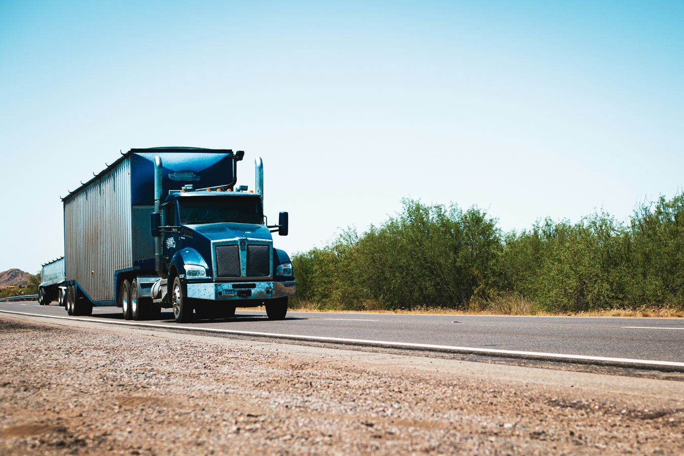 Blue semi truck on a highway route