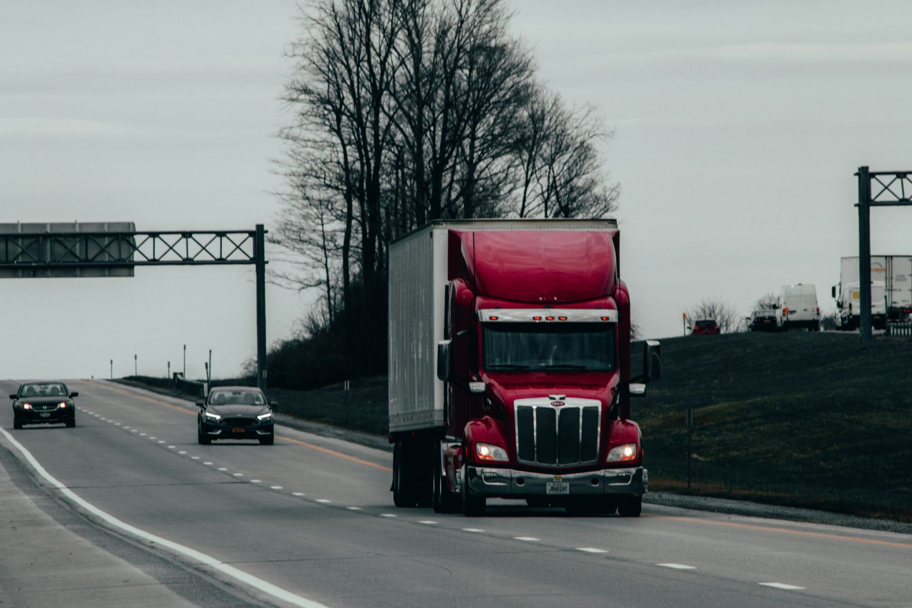 Semi truck hauling dry van freight on a highway