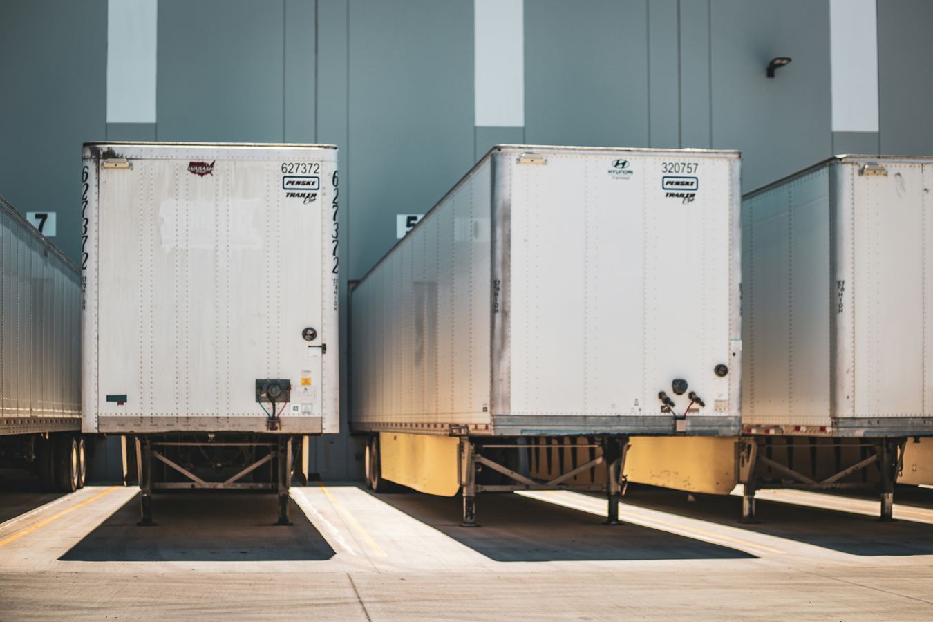 Dry van trailers parked at a loading dock